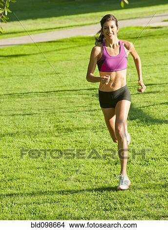 Hispanic woman running in park View Large Photo Image Picture - Hispanic woman running in park. Fotosearch