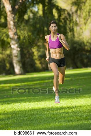 Hispanic woman running in park View Large Photo Image Stock Image - Hispanic woman running in park. Fotosearch
