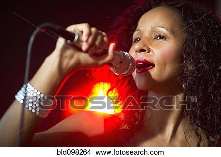Hispanic woman singing in nightclub View Large Photo Image Picture - Hispanic woman singing in nightclub. Fotosearch