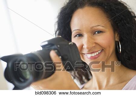 Hispanic woman taking photographs with camera View Large Photo Image Stock Photograph - Hispanic woman taking photographs with camera. Fotosearch