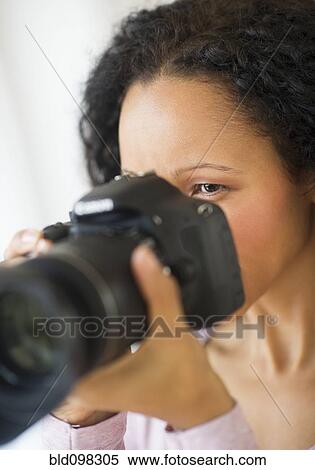 Hispanic woman taking photographs with camera View Large Photo Image Stock Photography - Hispanic woman taking photographs with camera. Fotosearch