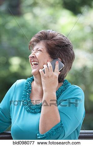 Hispanic woman talking on cell phone View Large Photo Image Stock Photo - Hispanic woman talking on cell phone. Fotosearch