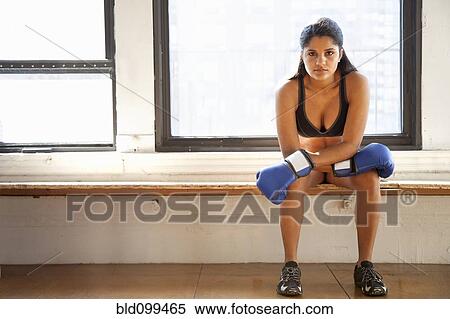Stock Photography - Hispanic woman training in boxing gloves. Fotosearch