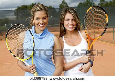 Hispanic women standing together on tennis court View Large Photo Image Stock Photo - Hispanic women standing together on tennis court. Fotosearch
