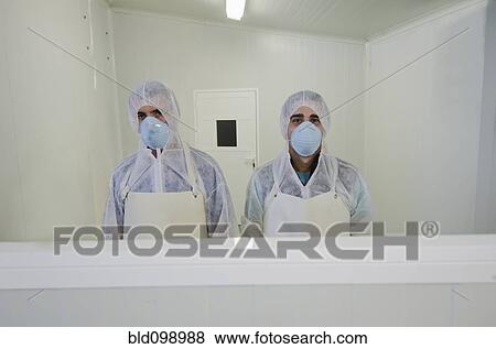 Stock Photo - Hispanic workers in protective clothing. Fotosearch