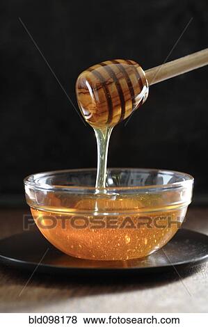 Honey dripping off of dipper View Large Photo Image Stock Photo - Honey dripping off of dipper. Fotosearch