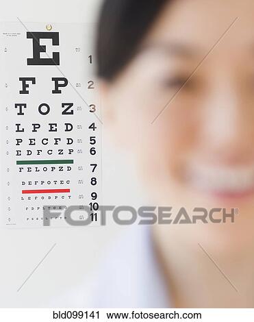Japanese optometrist in front of eye chart View Large Photo Image Stock Image - Japanese optometrist in front of eye chart. Fotosearch