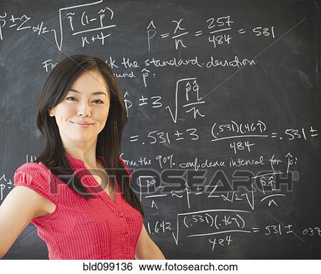 Stock Photograph - Japanese teacher standing near blackboard. Fotosearch