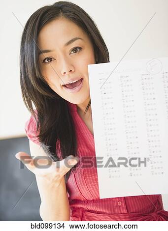 Picture - Japanese woman holding failing test. Fotosearch