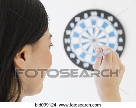 Japanese woman throwing dart at dartboard View Large Photo Image Picture - Japanese woman throwing dart at dartboard. Fotosearch