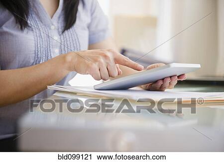 Stock Image - Japanese woman using digital tablet. Fotosearch