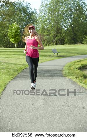 Stock Photo - Jogger running in park. Fotosearch