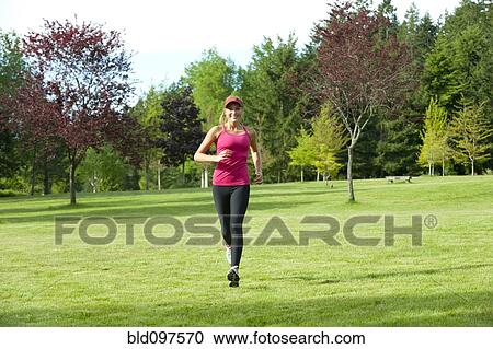Jogger running through field View Large Photo Image Stock Image - Jogger running through field. Fotosearch
