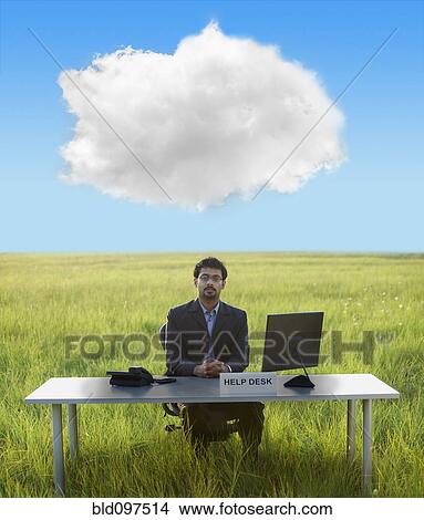 Picture - Middle Eastern businessman at help desk in field. Fotosearch