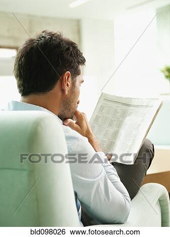 Mixed race businessman reading newspaper View Large Photo Image Stock Photograph - Mixed race businessman reading newspaper. Fotosearch