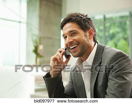 Stock Photo - Mixed race businessman talking on cell phone. Fotosearch