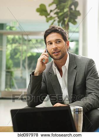 Mixed race businessman talking on cell phone View Large Photo Image Stock Photo - Mixed race businessman talking on cell phone. Fotosearch