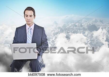 Stock Photo - Mixed race businessman using laptop in clouds. Fotosearch