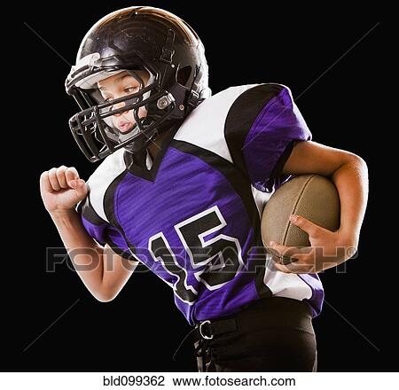 Mixed race football player running with football View Large Photo Image Stock Image - Mixed race football player running with football. Fotosearch