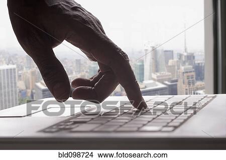 Picture - Mixed race man typing on laptop. Fotosearch