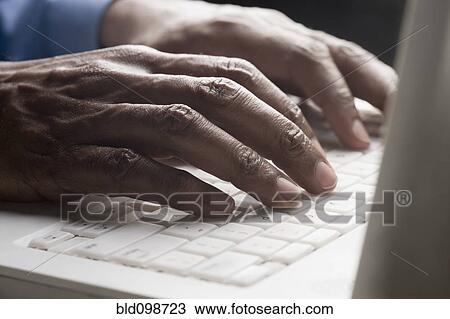 Mixed race man typing on laptop View Large Photo Image Stock Image - Mixed race man typing on laptop. Fotosearch