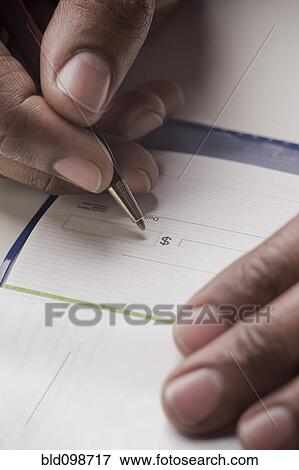Stock Photo - Mixed race man writing a check. Fotosearch