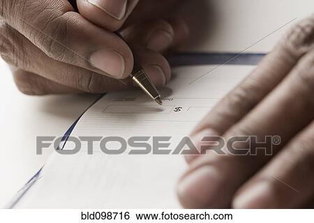 Stock Photograph - Mixed race man writing a check. Fotosearch