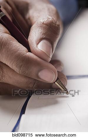 Stock Photography - Mixed race man writing a check. Fotosearch