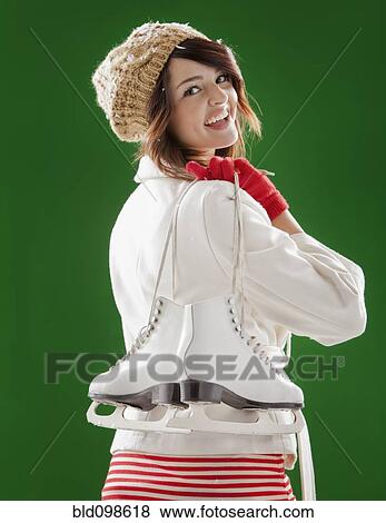 Mixed race woman carrying ice skates View Large Photo Image Stock Photo - Mixed race woman carrying ice skates. Fotosearch