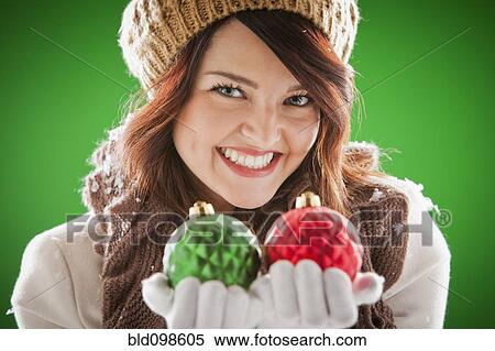 Mixed race woman holding Christmas ornaments View Large Photo Image Stock Photography - Mixed race woman holding Christmas ornaments. Fotosearch