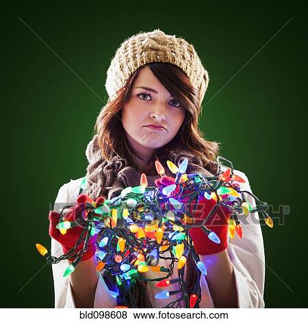 Mixed race woman holding tangle of Christmas lights View Large Photo Image Stock Photo - Mixed race woman holding tangle of Christmas lights. Fotosearch