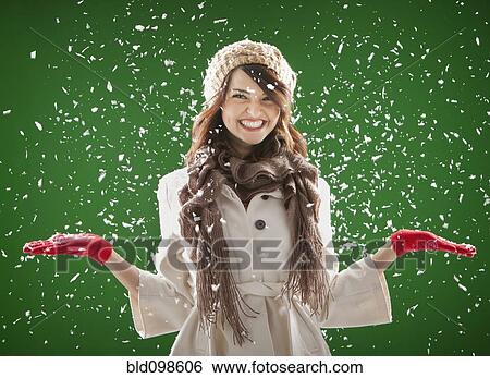 Stock Photograph - Mixed race woman standing in the snow. Fotosearch