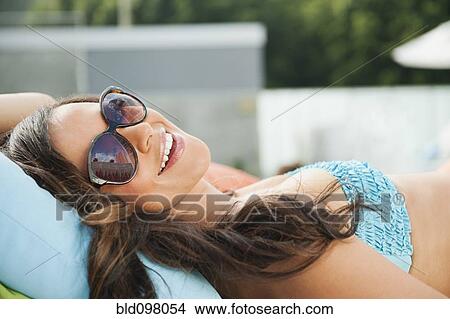 Mixed race woman sunbathing View Large Photo Image Picture - Mixed race woman sunbathing. Fotosearch