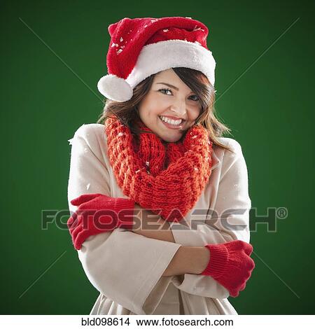 Mixed race woman wearing scarf and Santa hat View Large Photo Image Picture - Mixed race woman wearing scarf and Santa hat. Fotosearch