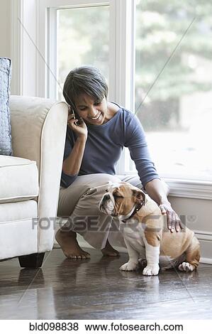 Stock Photo - Native American woman petting English bulldog. Fotosearch