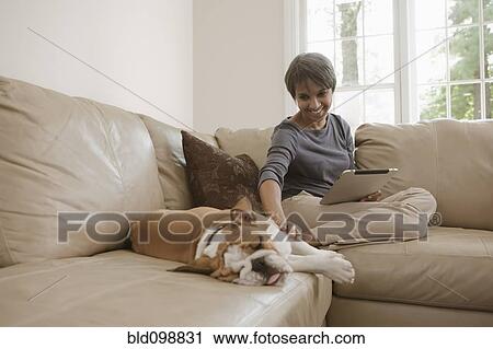 Native American woman sitting on sofa with English bulldog View Large Photo Image Stock Image - Native American woman sitting on sofa with English bulldog. Fotosearch