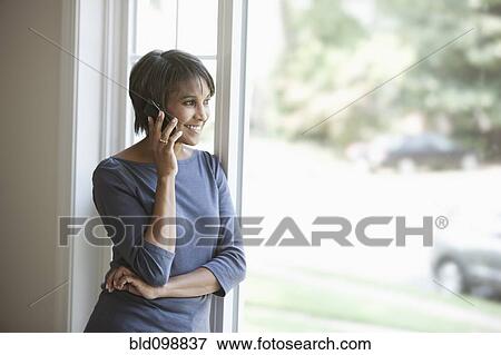 Stock Photo - Native American woman talking on cell phone. Fotosearch