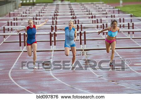 Runners crossing finish line in race View Large Photo Image Stock Photograph - Runners crossing finish line in race. Fotosearch