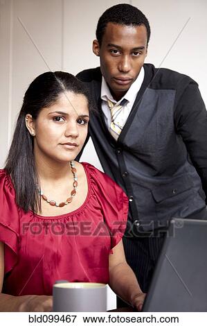 Serious business people in office View Large Photo Image Stock Photo - Serious business people in office. Fotosearch