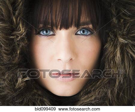 Stock Photo - Serious Caucasian woman in fur hood. Fotosearch