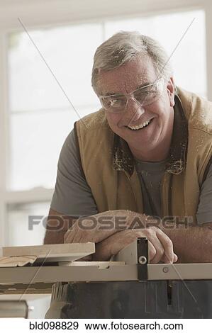 Stock Photo - Smiling Caucasian carpenter. Fotosearch