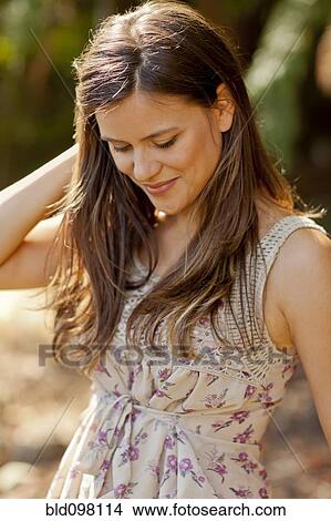 Smiling Caucasian woman standing outdoors View Large Photo Image Picture - Smiling Caucasian woman standing outdoors. Fotosearch