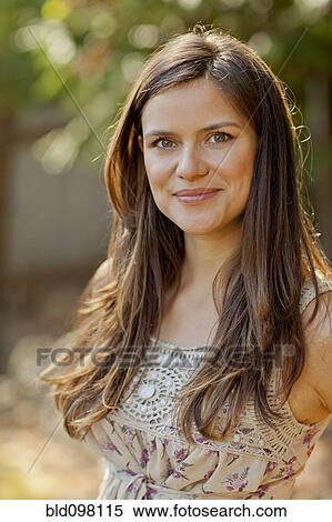 Smiling Caucasian woman standing outdoors View Large Photo Image Stock Photography - Smiling Caucasian woman standing outdoors. Fotosearch