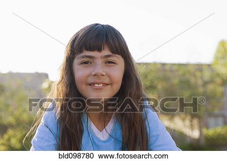 Stock Image - Smiling Chilean girl outdoors. Fotosearch