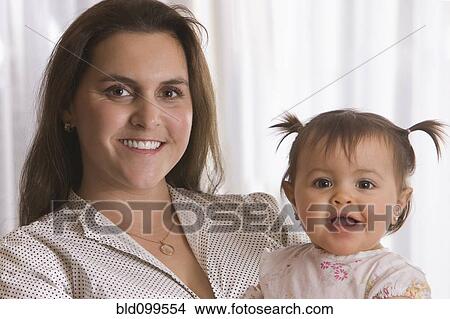 Smiling Chilean mother holding daughter View Large Photo Image Picture - Smiling Chilean mother holding daughter. Fotosearch