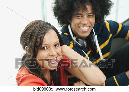 Stock Photography - Smiling couple sitting together. Fotosearch