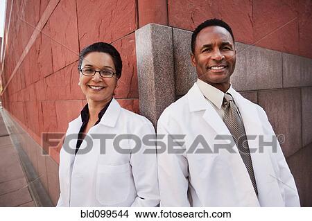Picture - Smiling doctors standing outdoors. Fotosearch