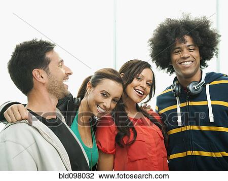Smiling friends standing together View Large Photo Image Stock Image - Smiling friends standing together. Fotosearch