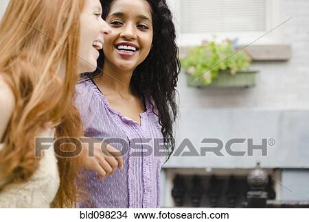Picture - Smiling friends walking outdoors. Fotosearch
