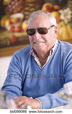 Stock Photograph - Smiling Hispanic man in sunglasses. Fotosearch